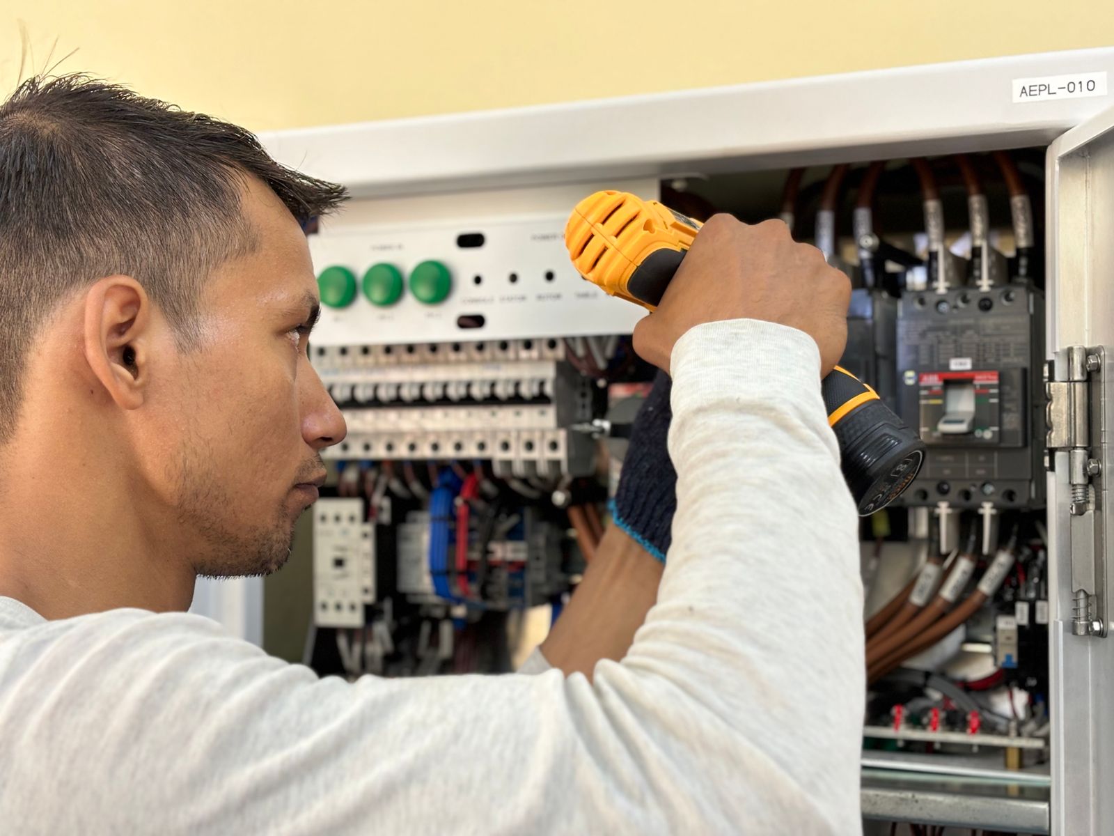 Illustrative stock photo of an electrician working at an electrical cabinet